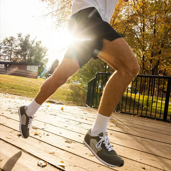 A man running in a park wearing the Splay RUNNER V1 barefoot running shoes.