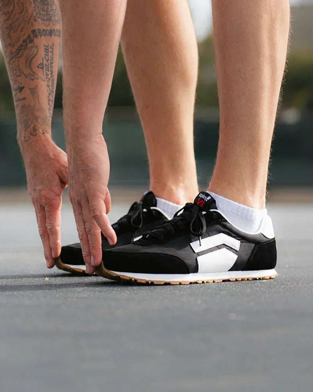 Black Splay barefoot sneakers styled outdoors with a natural performance look.