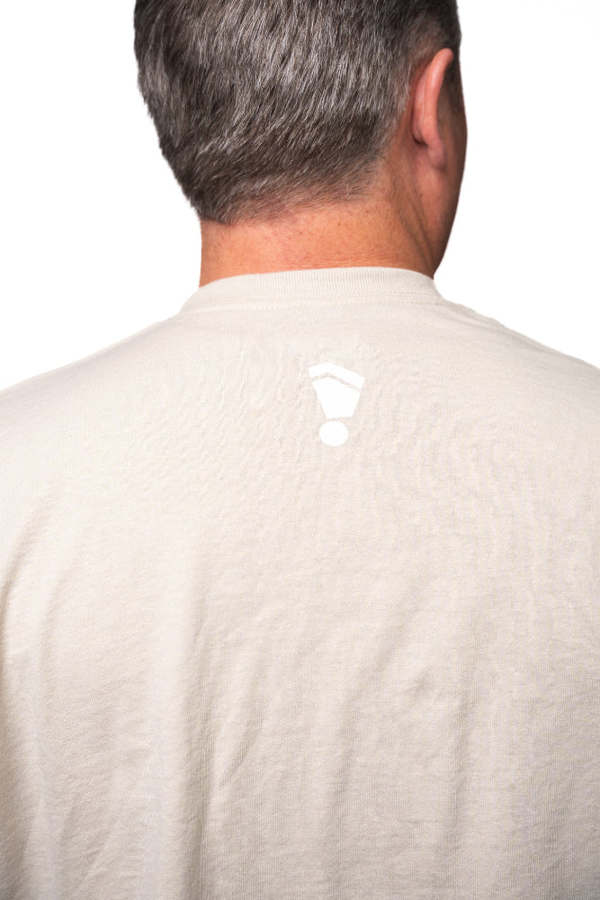 Back view of a person wearing a beige shirt on a white background