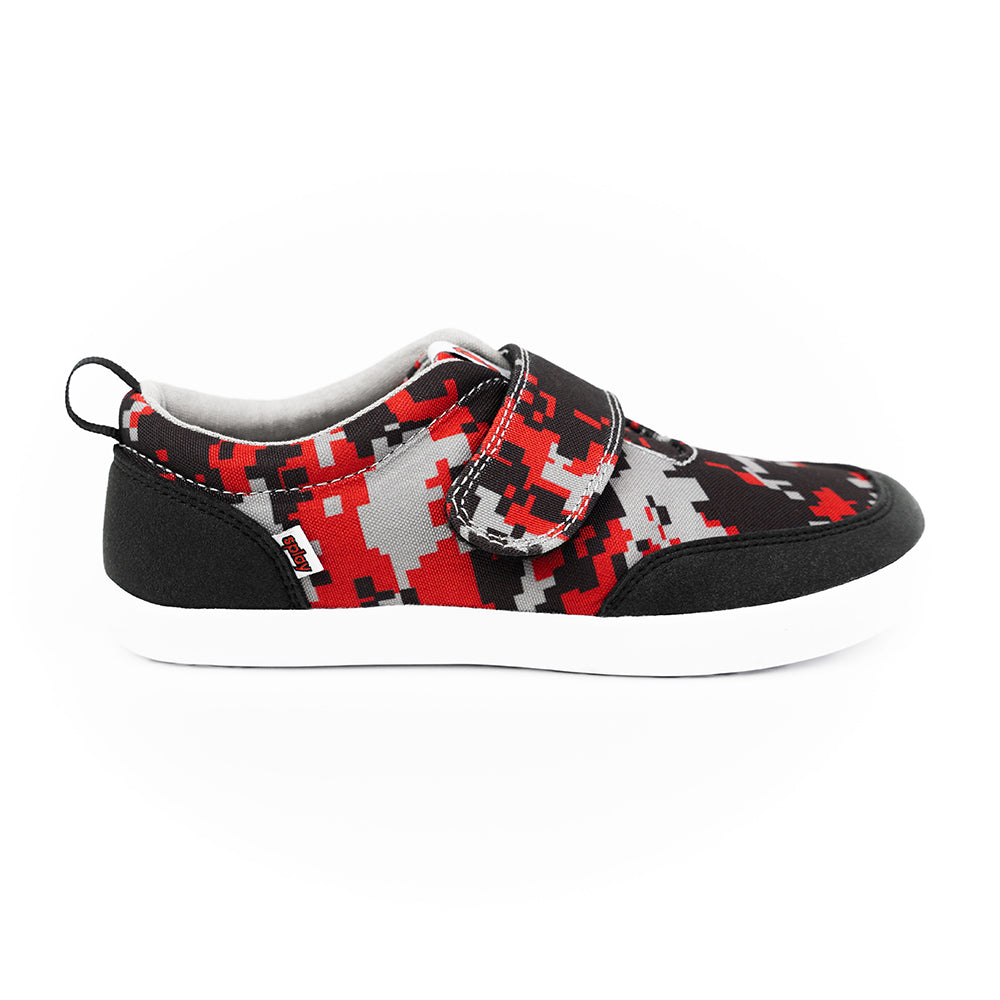 Side view of the Splay Explore Wild² Digicam Red kids’ shoe, featuring a bold red, black, and grey camo pattern with a wide toe box and flexible sole for natural foot movement.
