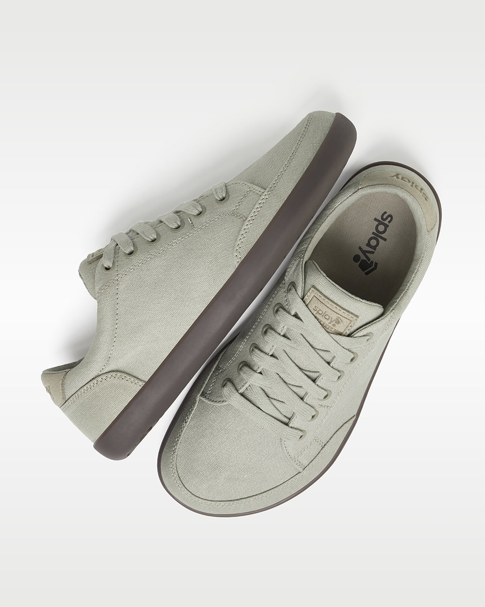 Splay Freestyle Ash barefoot shoes — minimal low-top lace-up sneaker, pair shot from above, one shoe tipped up to show the insole