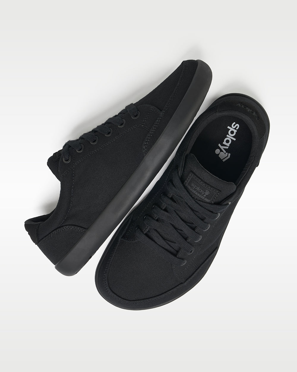 Splay Freestyle Jet barefoot shoes — minimal low-top lace-up sneaker, pair shot from above, one shoe tipped up to show the insole