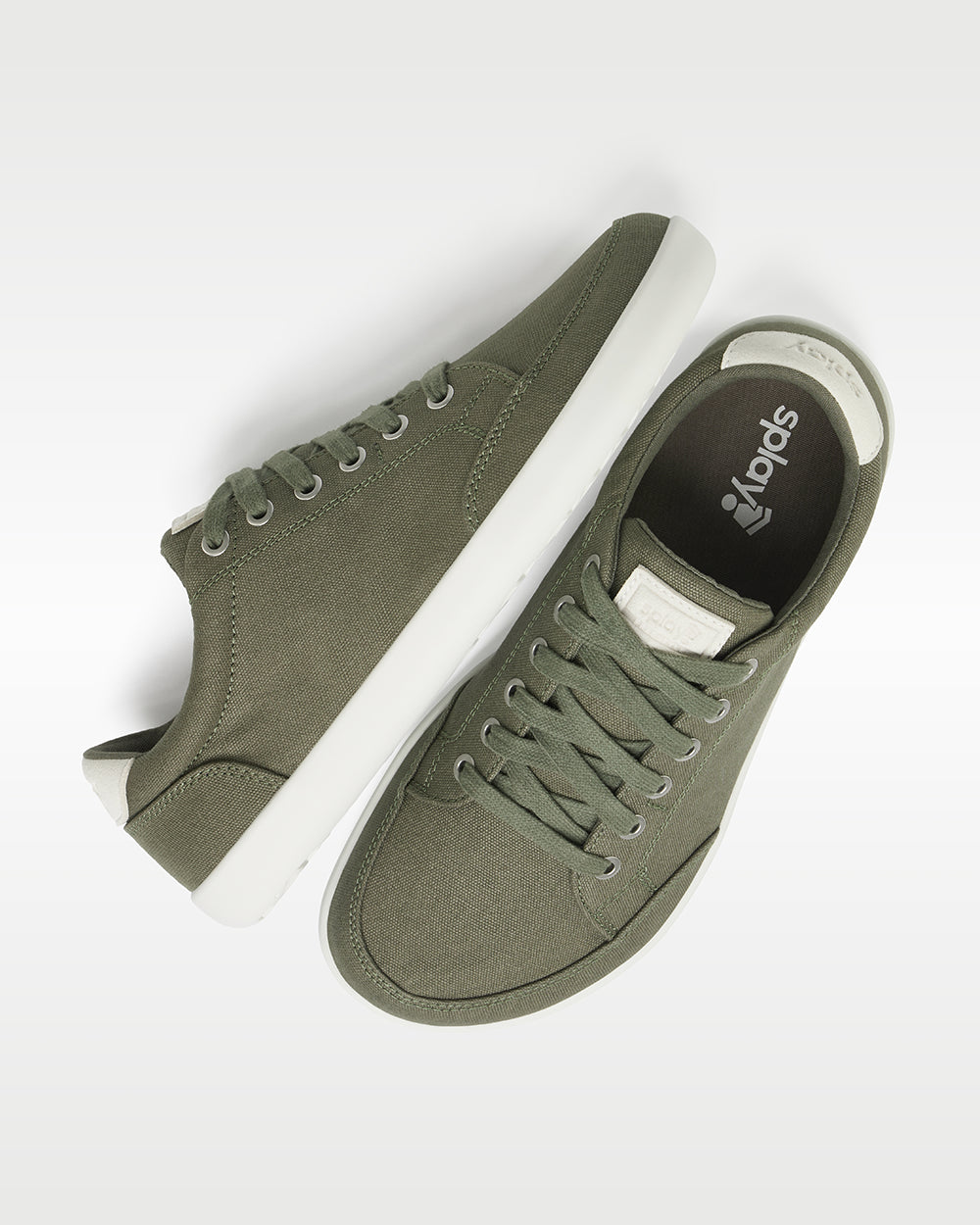 Splay Freestyle Sage barefoot shoes — minimal low-top lace-up sneaker, pair shot from above, one shoe tipped up to show the insole