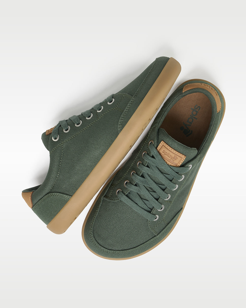 Splay Freestyle Spruce barefoot shoes — minimal low-top lace-up sneaker, pair shot from above, one shoe tipped up to show the insole