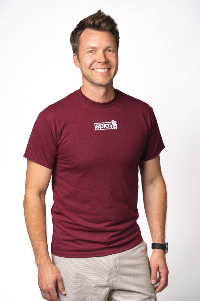 Man wearing a maroon t-shirt with a logo on a white background