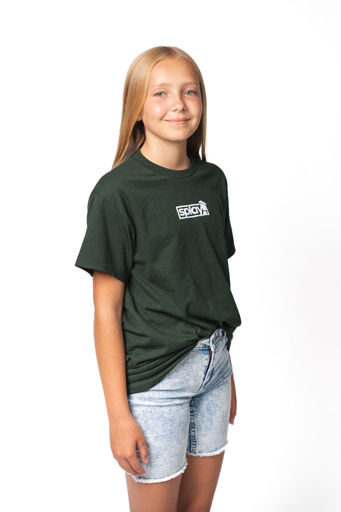 Young girl wearing a green t-shirt with a logo on a white background