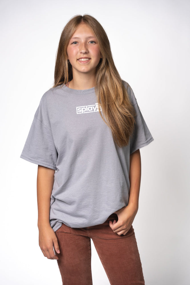Person wearing a gray t-shirt with a logo on a white background