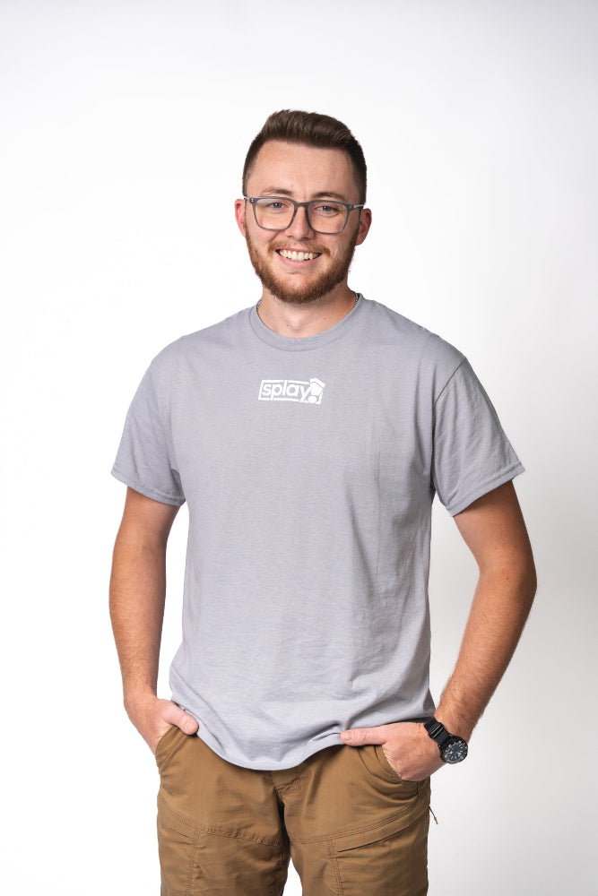 Man wearing a gray t-shirt with a logo on a white background