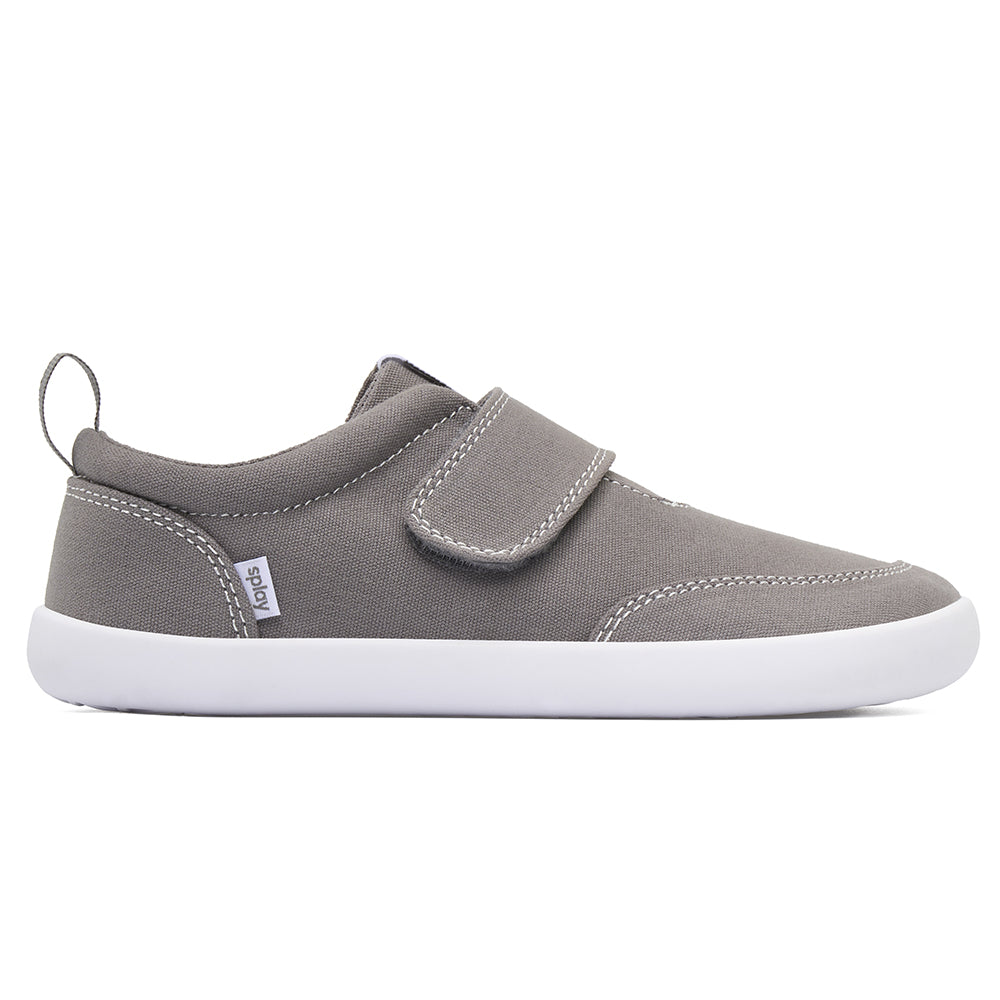 Gray kids’ barefoot shoe with wide toe box and Velcro strap for natural foot movement.