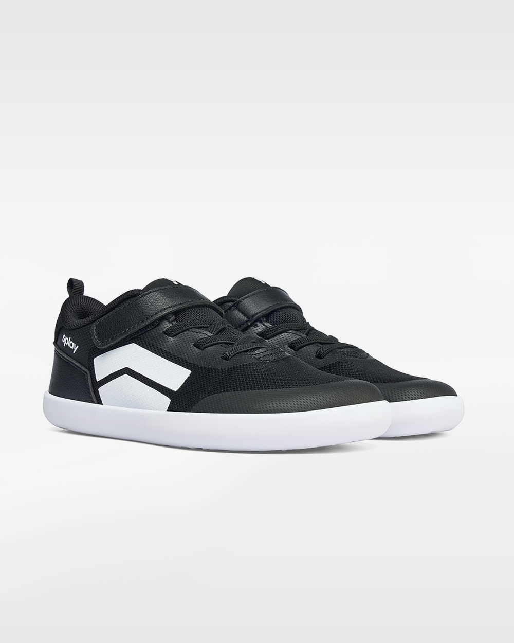 Splay Dash Kids Core Black barefoot shoes — kids' low-top sneaker with a strap and laces, pair in an angled three-quarter view from the front