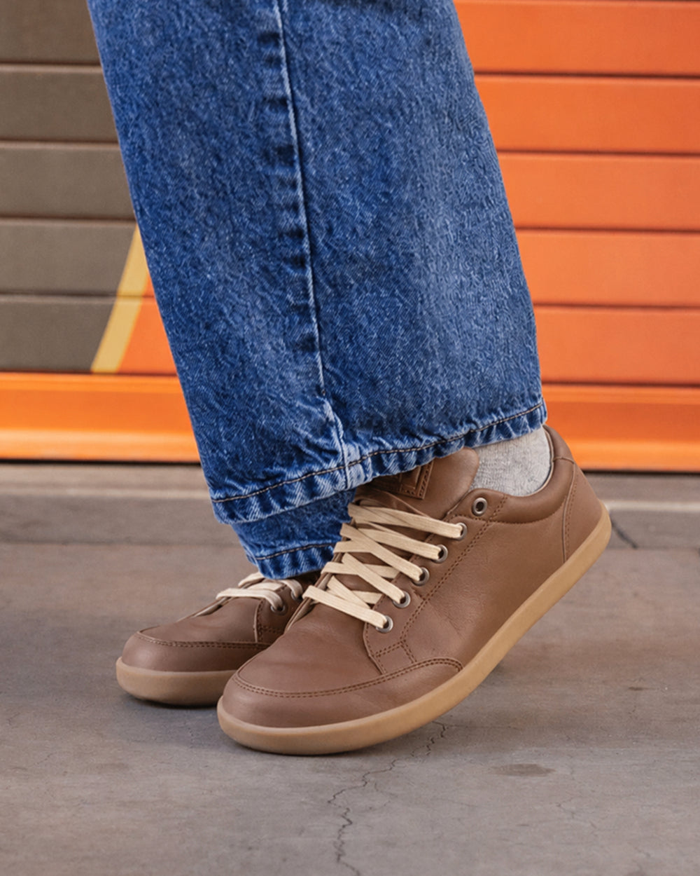 Splay Freestyle Leather Chestnut barefoot shoes — leather low-top lace-up sneaker, lifestyle photo, the shoes shown in use outdoors