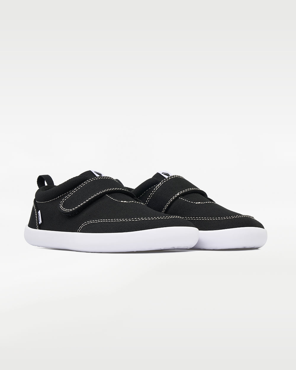 Splay Explore Kids Coal barefoot shoes — kids' low-top shoe with a hook-and-loop strap, pair in an angled three-quarter view from the front