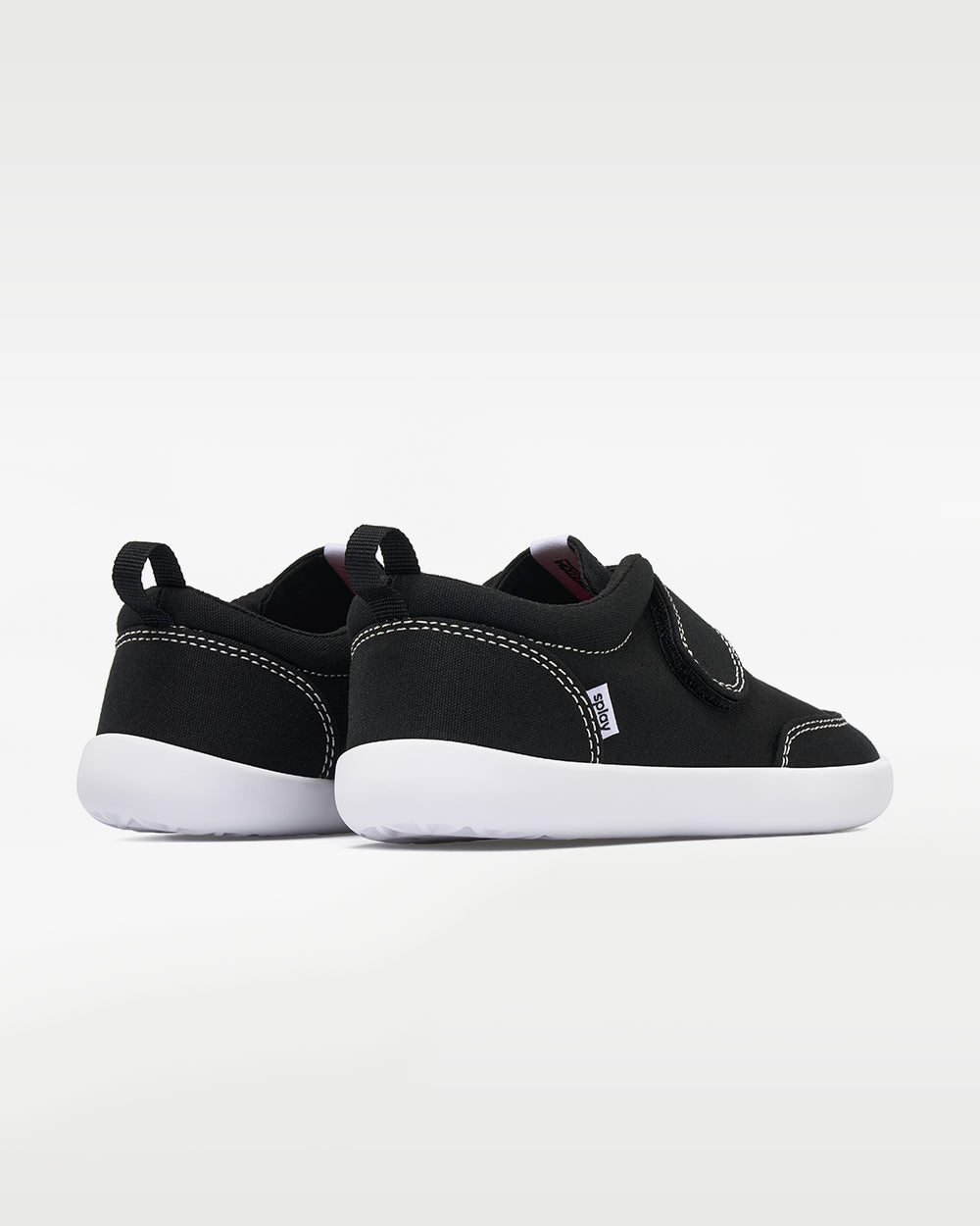 Splay Explore Kids Coal barefoot shoes — kids' low-top shoe with a hook-and-loop strap, pair viewed from behind, heels toward the camera