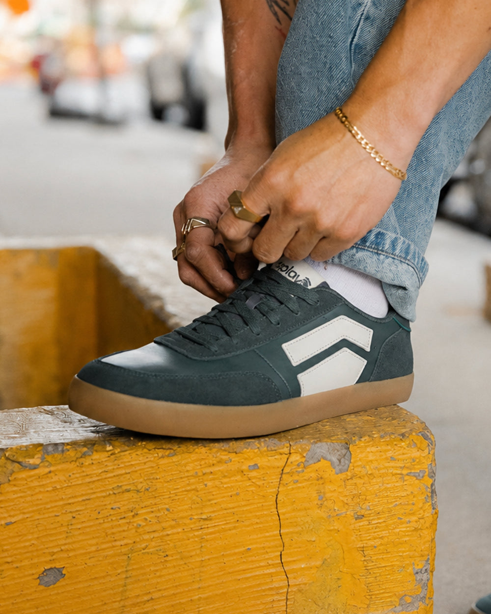 Splay 101 Ivy League Green '26 barefoot shoes — low-top court sneaker with a side stripe and gum sole, lifestyle photo, the shoes shown in use outdoors