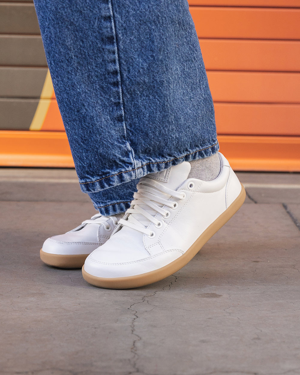 Splay Freestyle Leather Ivory barefoot shoes — leather low-top lace-up sneaker, lifestyle photo, the shoes shown in use outdoors
