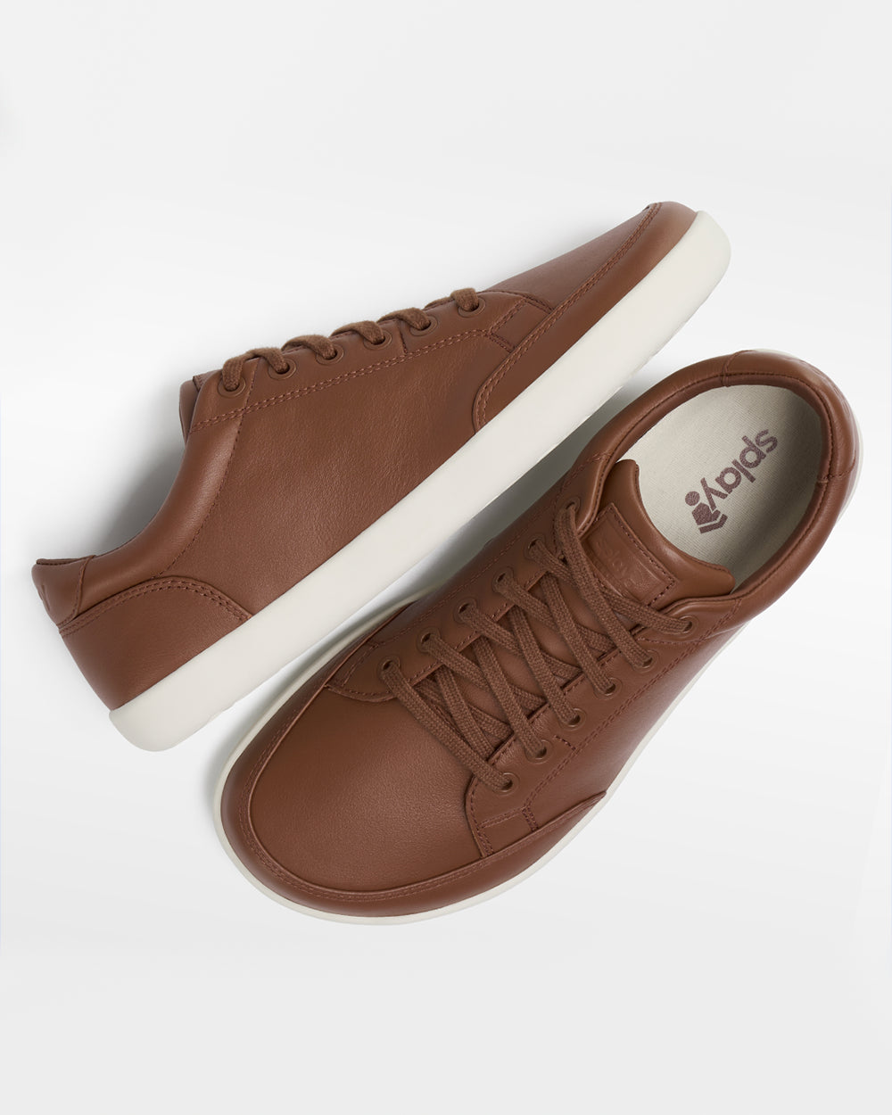 Splay Freestyle Leather Oak barefoot shoes — leather low-top lace-up sneaker, pair shot from above, one shoe tipped up to show the insole