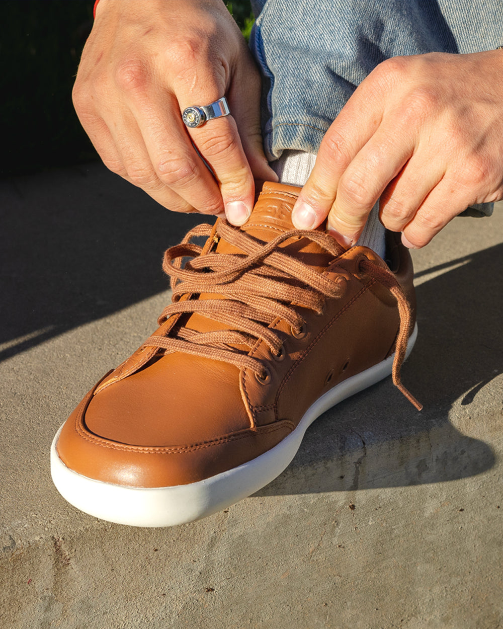 Splay Freestyle Leather Oak barefoot shoes — leather low-top lace-up sneaker, lifestyle photo, the shoes shown in use outdoors