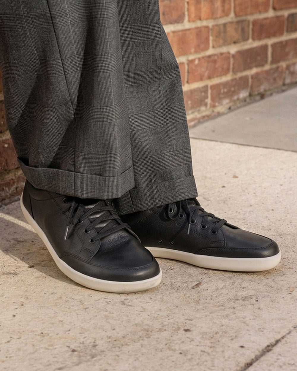 Splay Freestyle Leather Obsidian barefoot shoes — leather low-top lace-up sneaker, lifestyle photo, the shoes shown in use outdoors