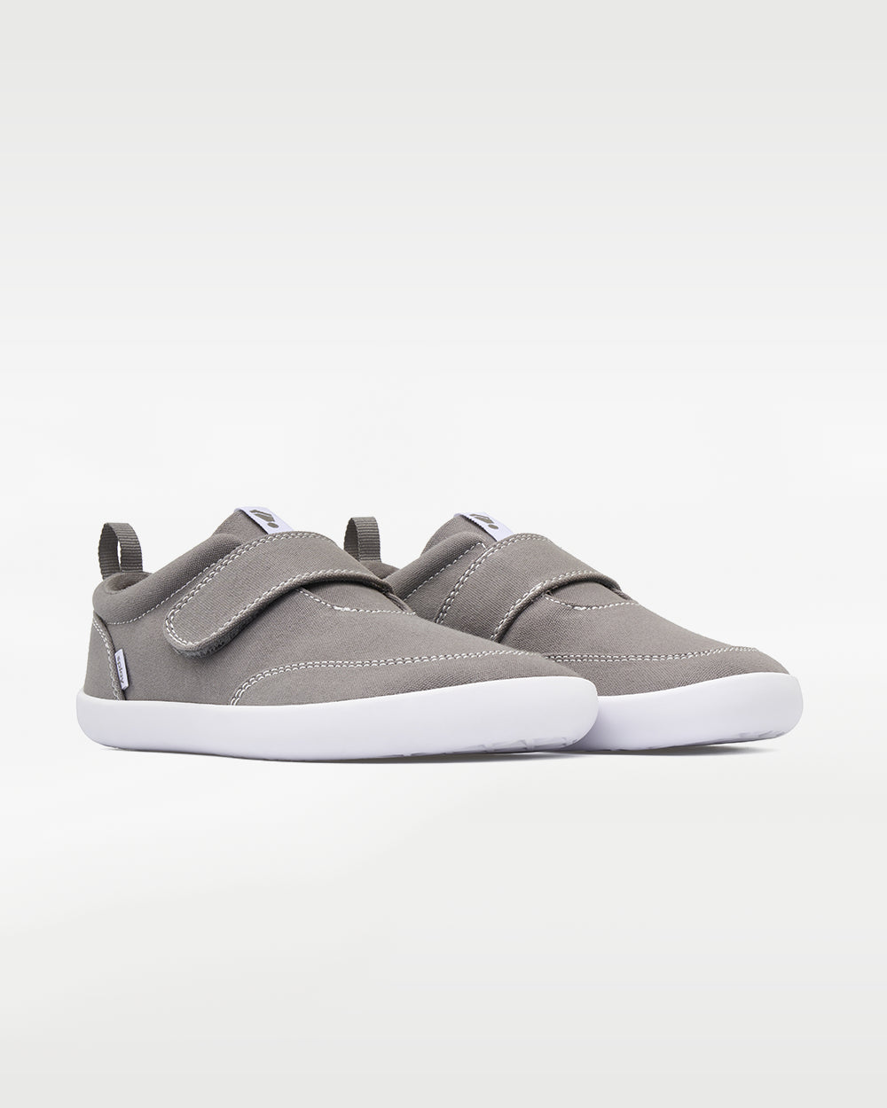 Splay Explore Kids Stone barefoot shoes — kids' low-top shoe with a hook-and-loop strap, pair in an angled three-quarter view from the front