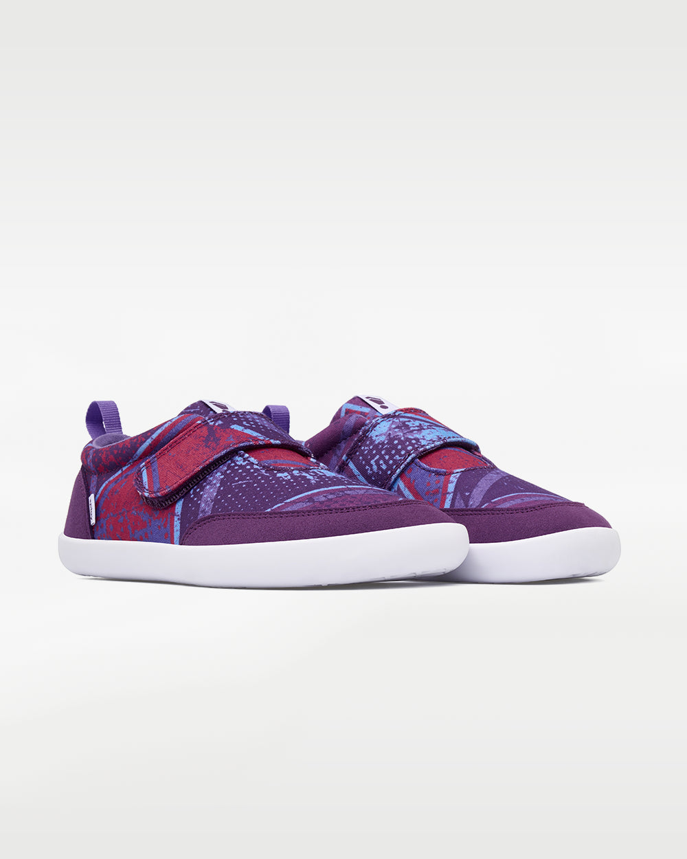Splay Explore Wild Kids Purple Pop barefoot shoes — kids' low-top shoe with a hook-and-loop strap, pair in an angled three-quarter view from the front