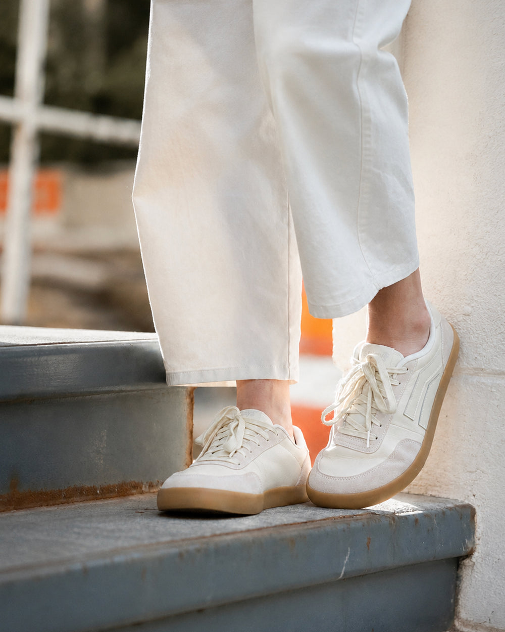 Splay 101 Whiteboard '26 barefoot shoes — low-top court sneaker with a side stripe and gum sole, lifestyle photo, the shoes shown in use outdoors